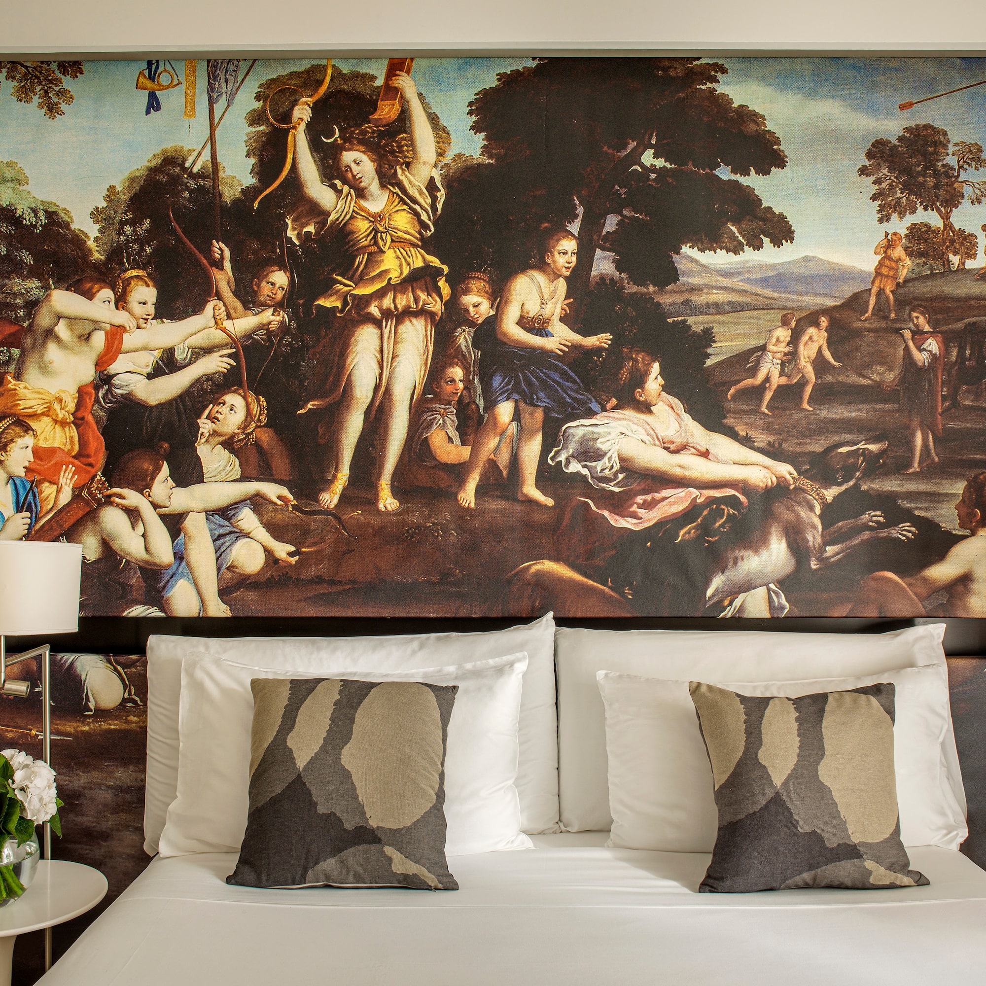 a bed with a painting above it
