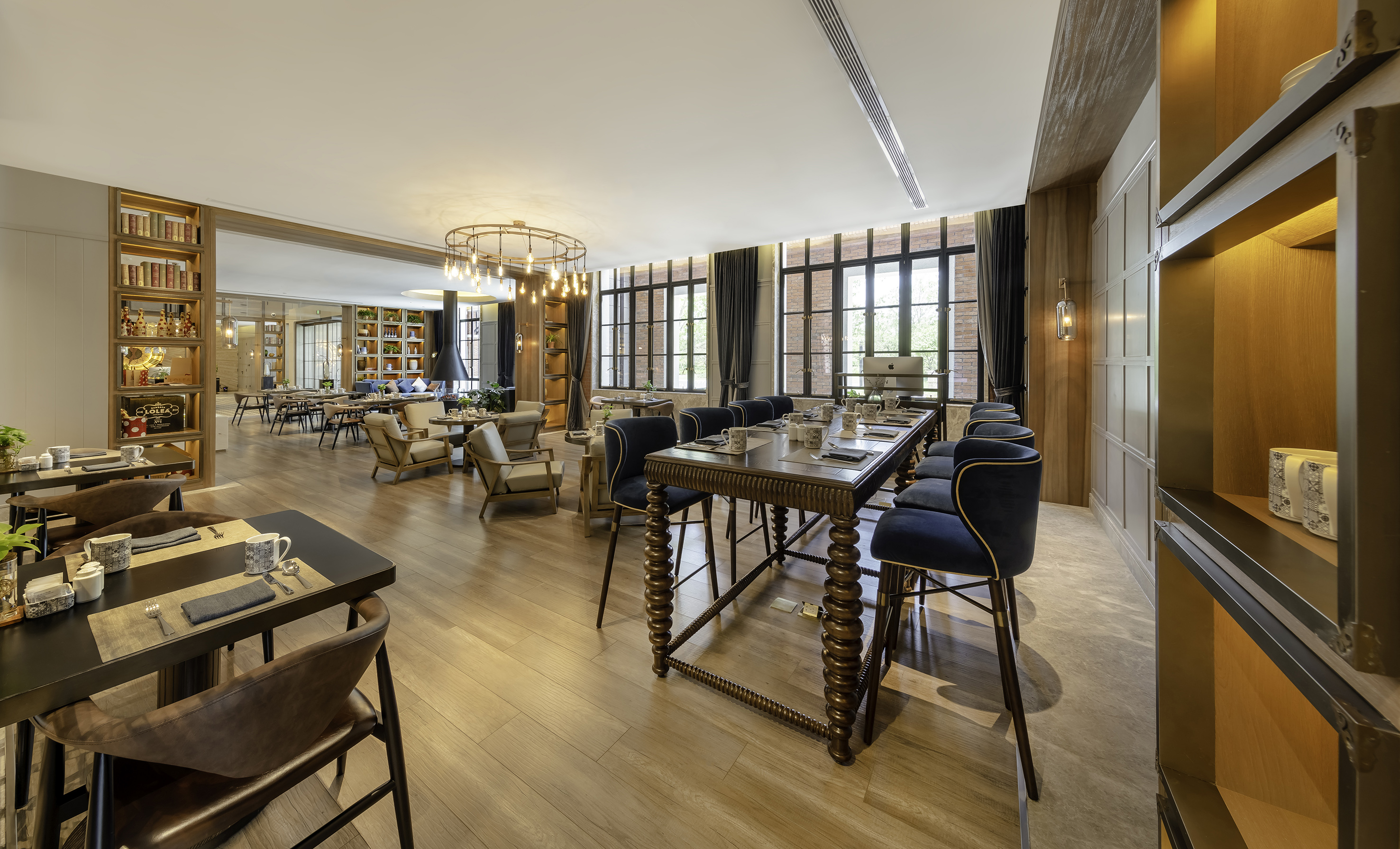 Elegant restaurant dining room with mixed seating and large windows.