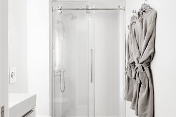 a bathroom with a glass shower and toilet