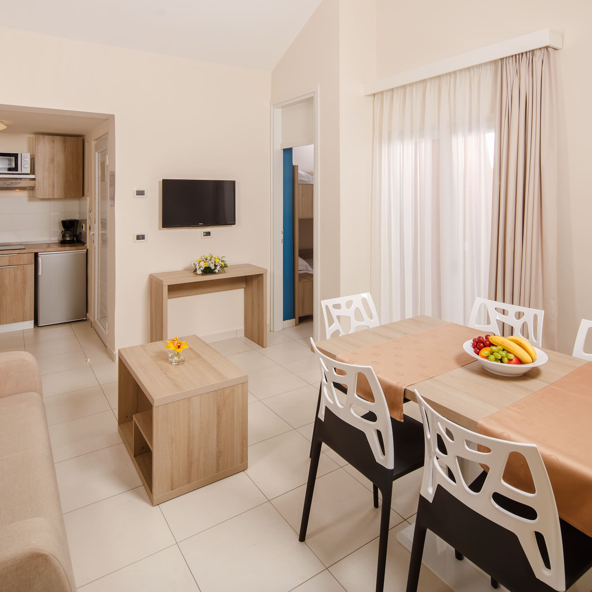 a living room with a table and chairs