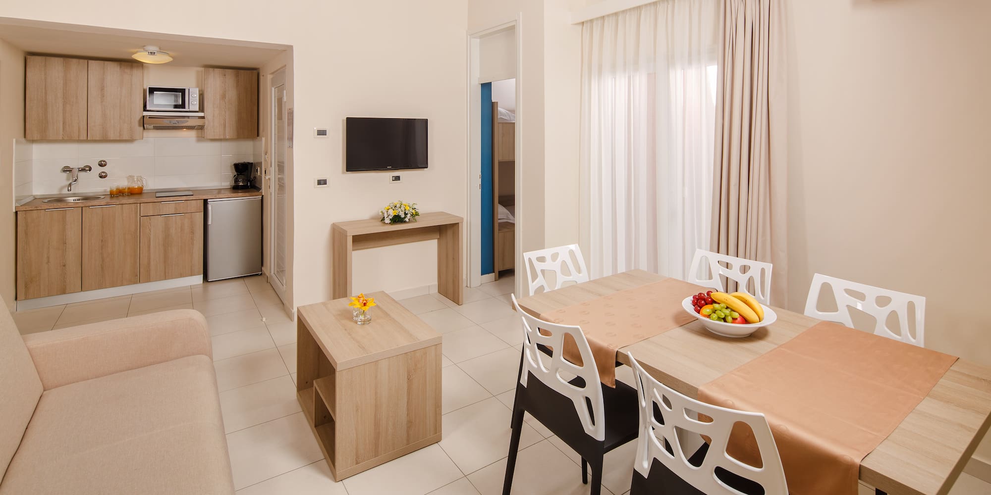 a living room with a table and chairs