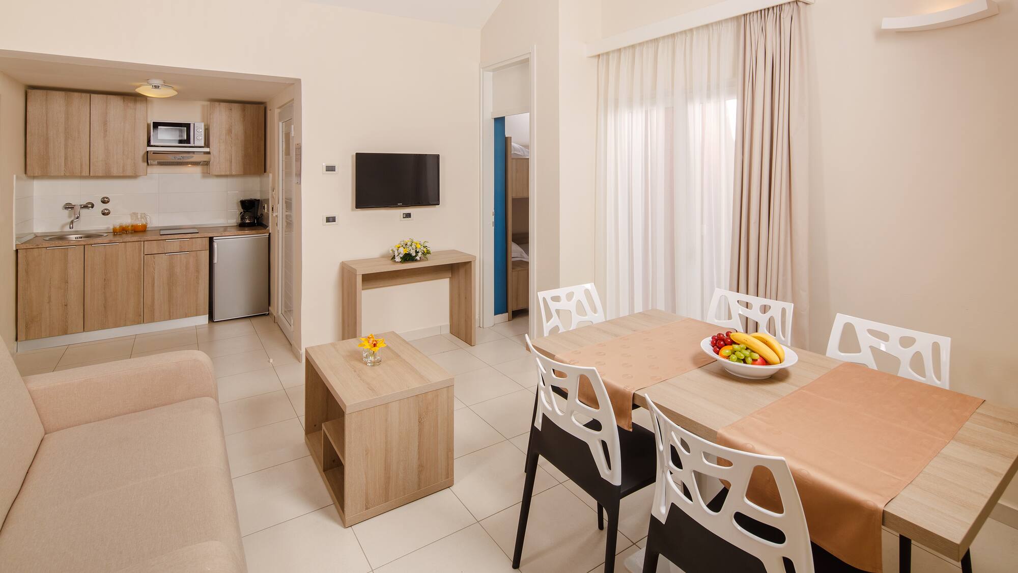 a living room with a table and chairs