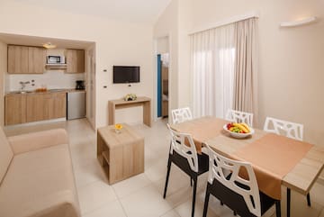 a living room with a table and chairs