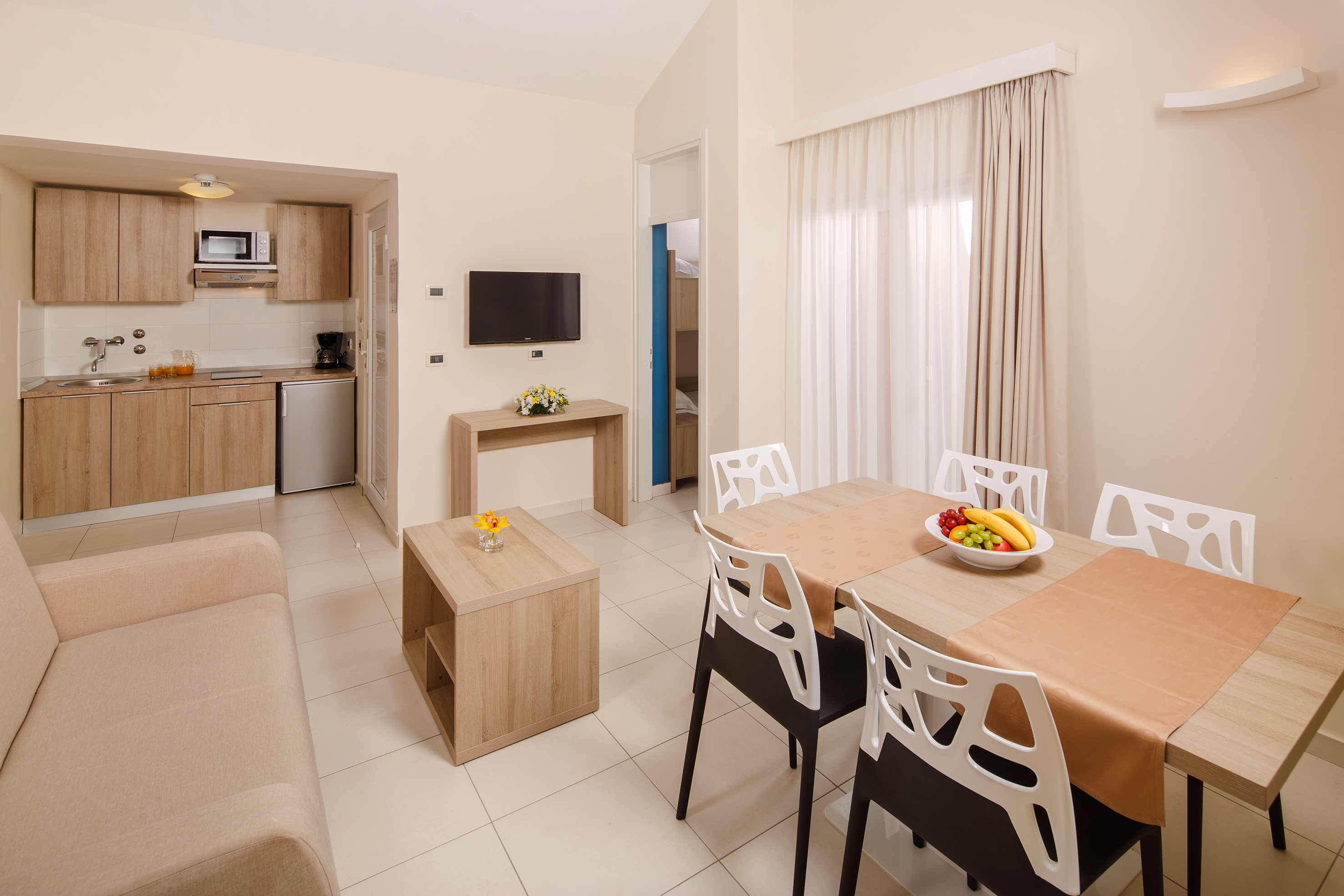 a living room with a table and chairs