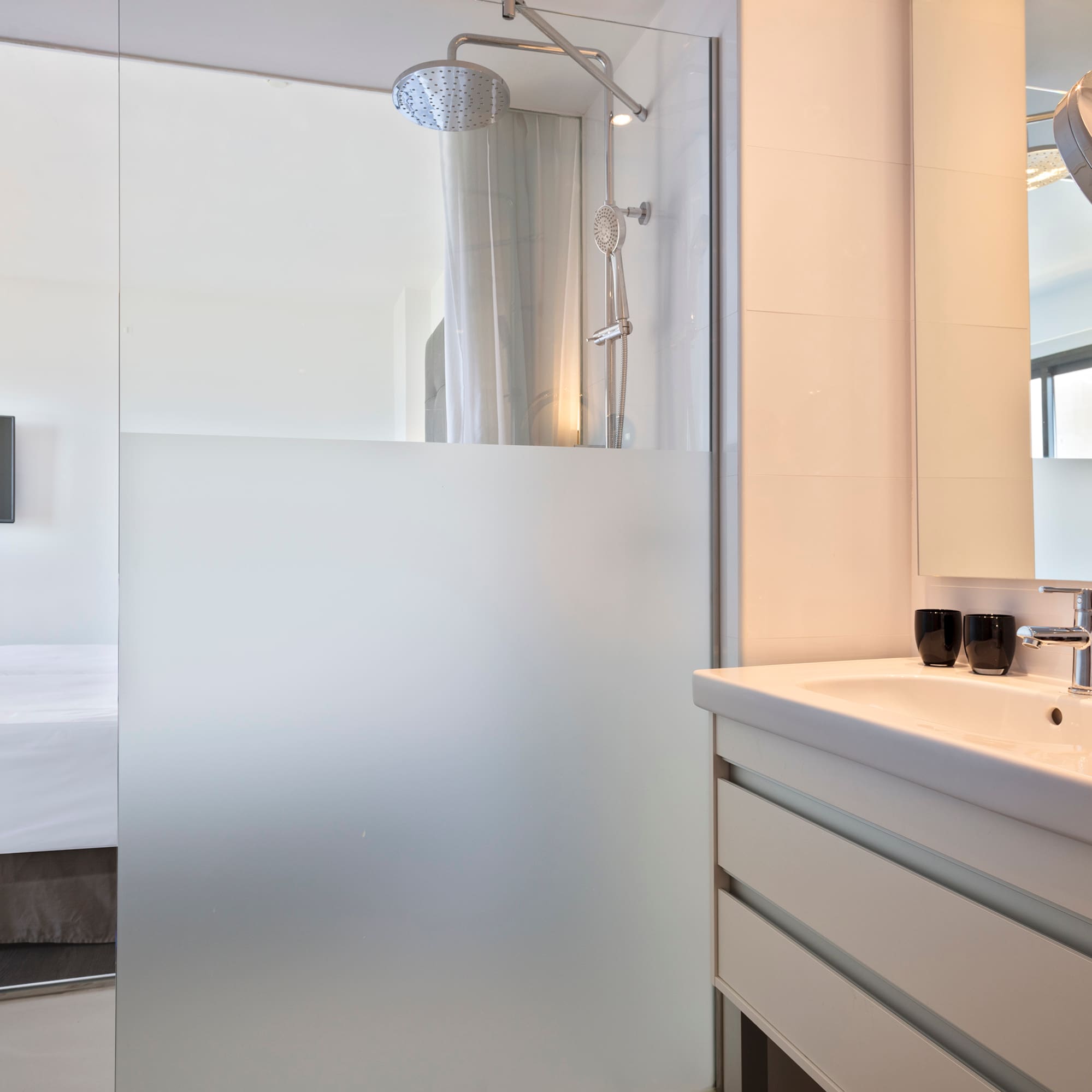 a bathroom with a glass shower door