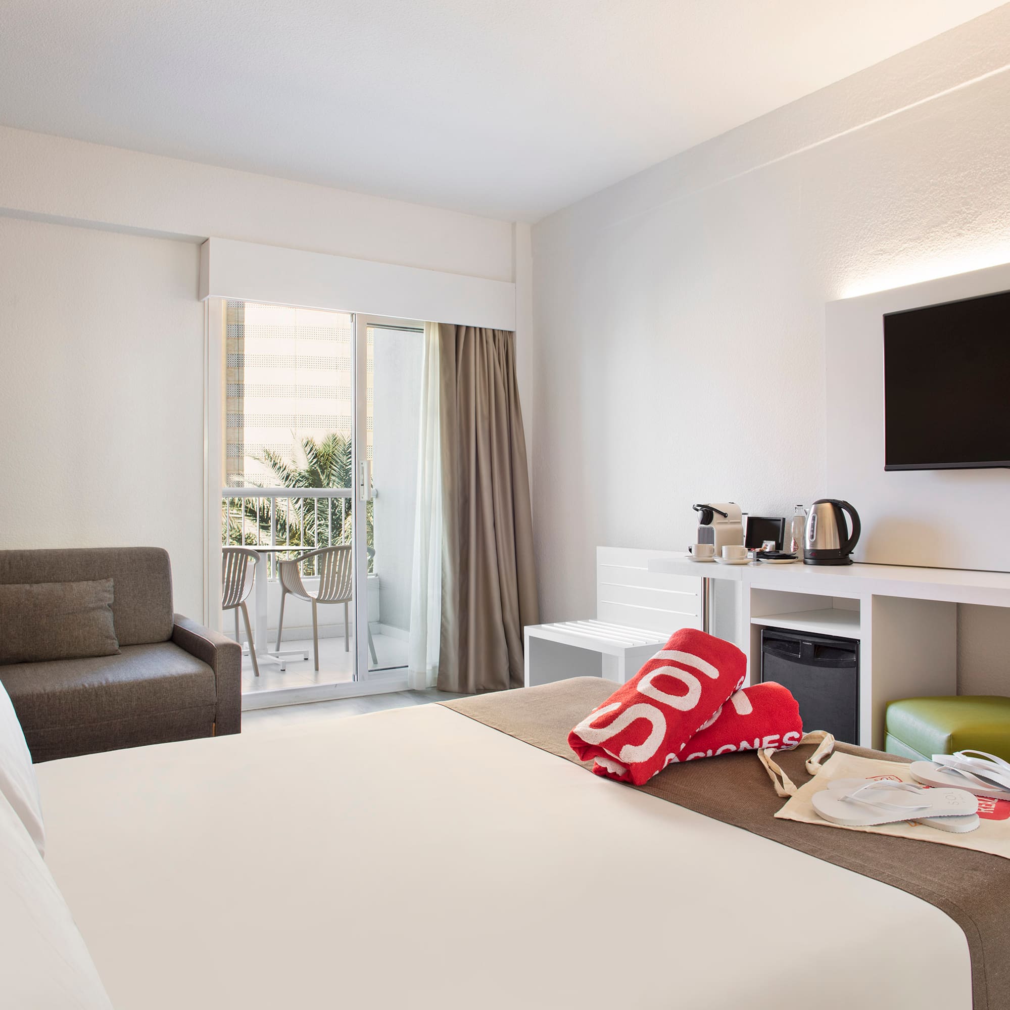 a hotel room with a bed and a television