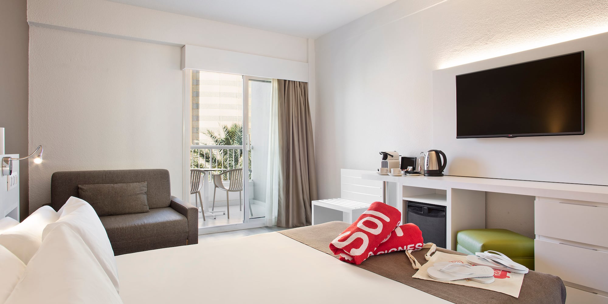 a hotel room with a bed and a television