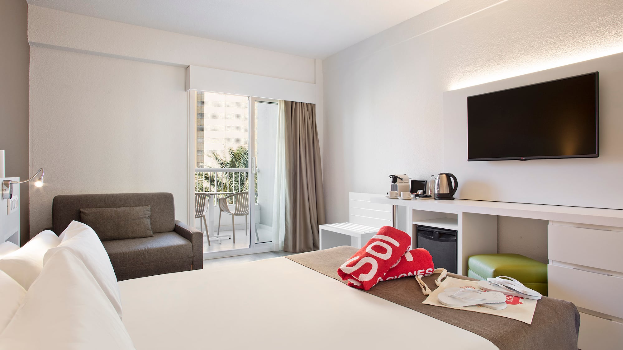 a hotel room with a bed and a television