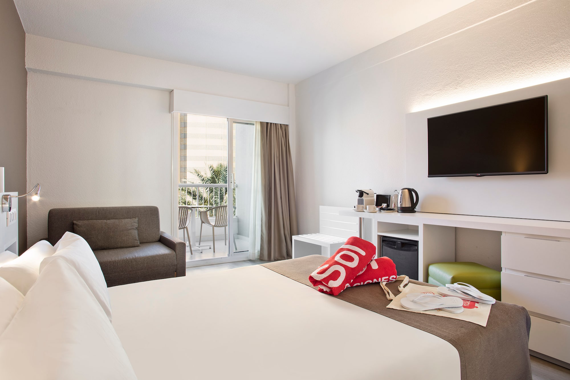 a hotel room with a bed and a television