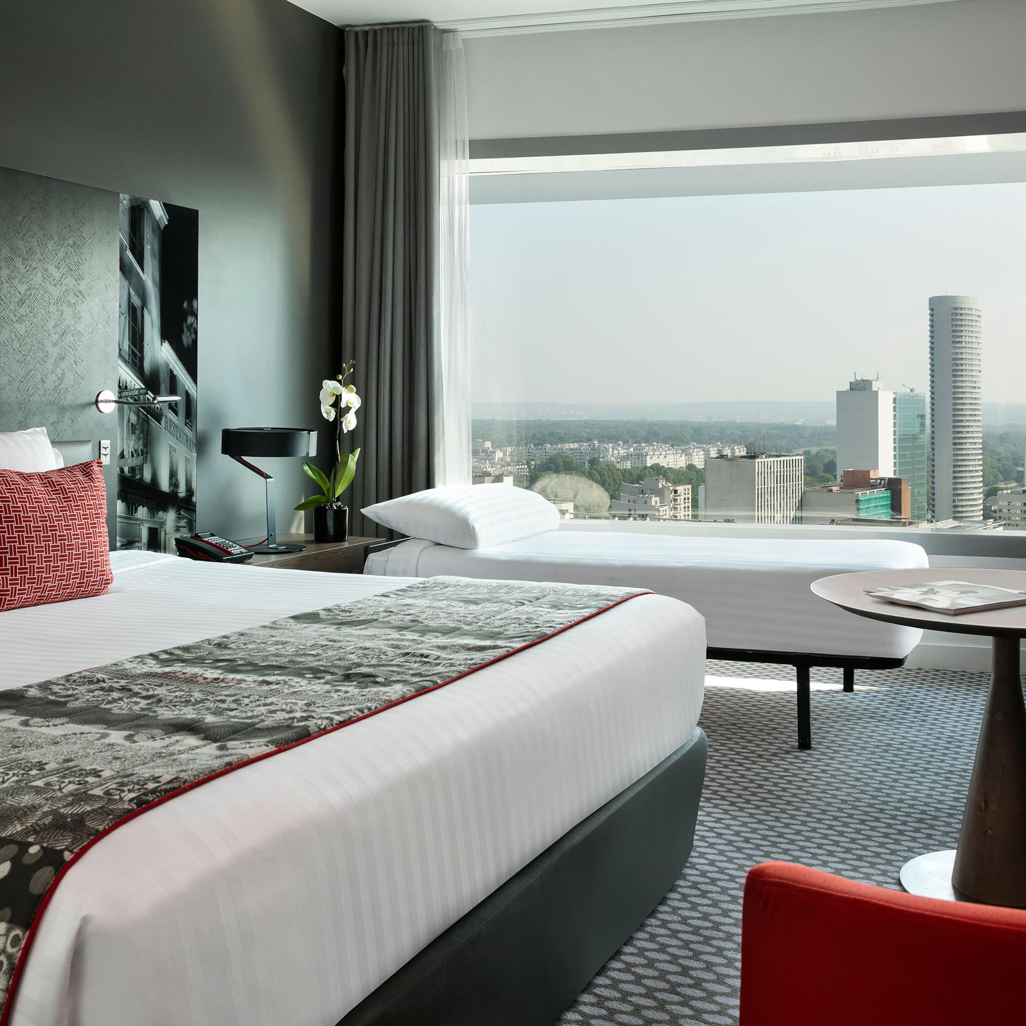 a room with a large window and a large bed