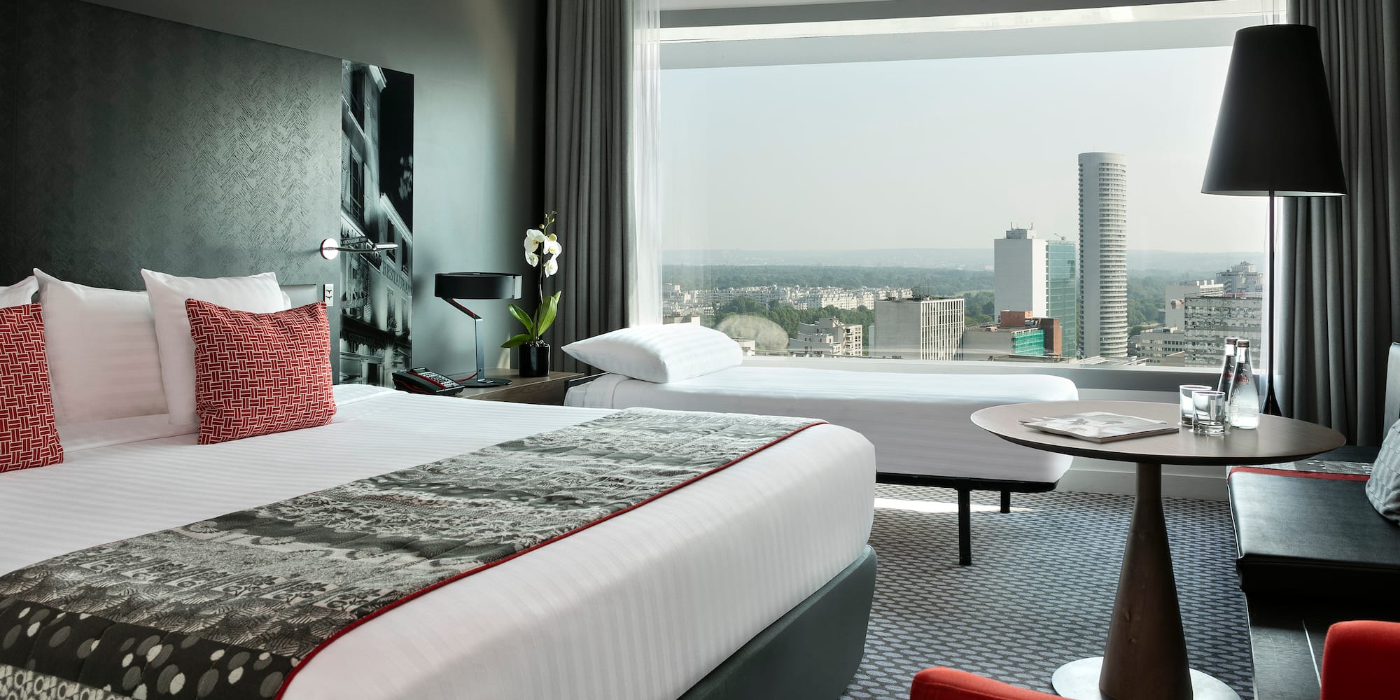 a room with a large window and a large bed