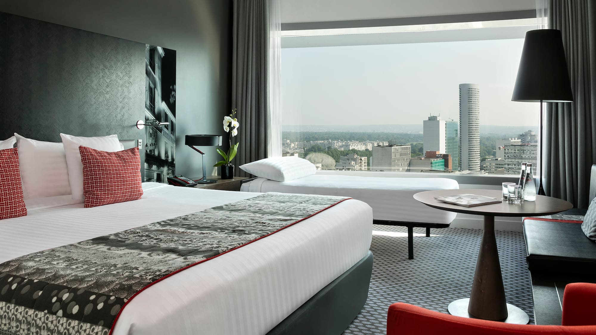 a room with a large window and a large bed