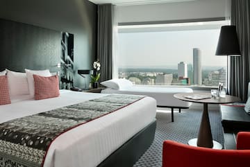 a room with a large window and a large bed