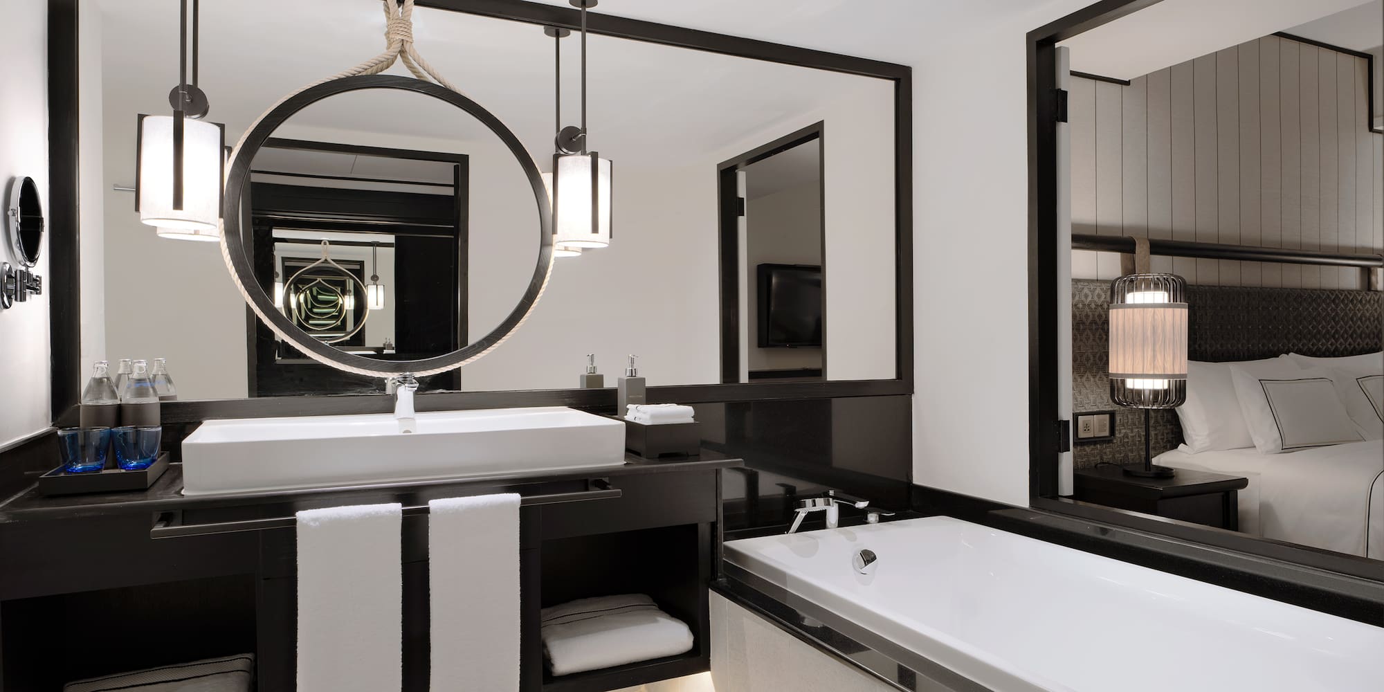 a bathroom with a large mirror and a bathtub