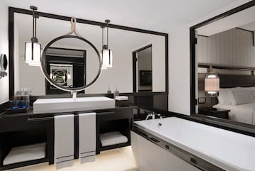 a bathroom with a large mirror and a bathtub