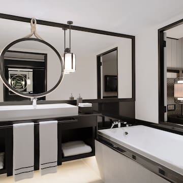 a bathroom with a large mirror and a bathtub