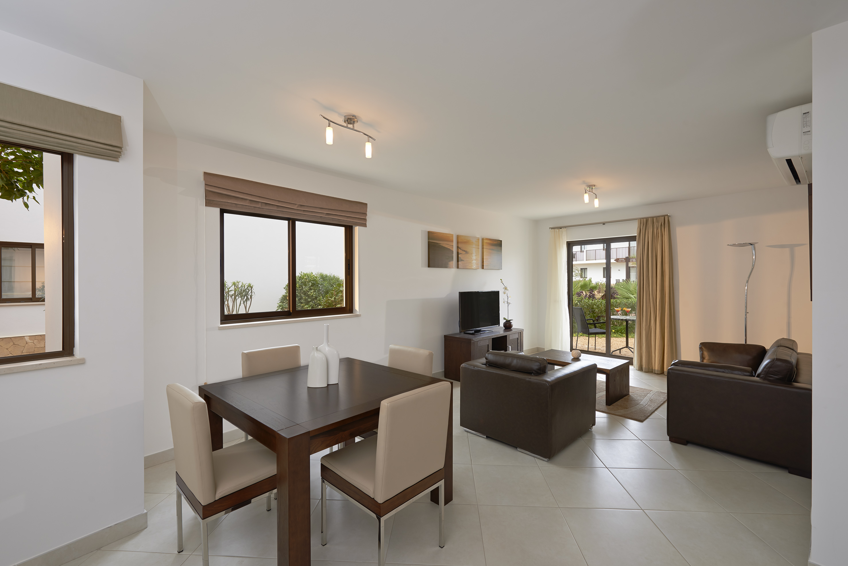 a living room with a table and chairs