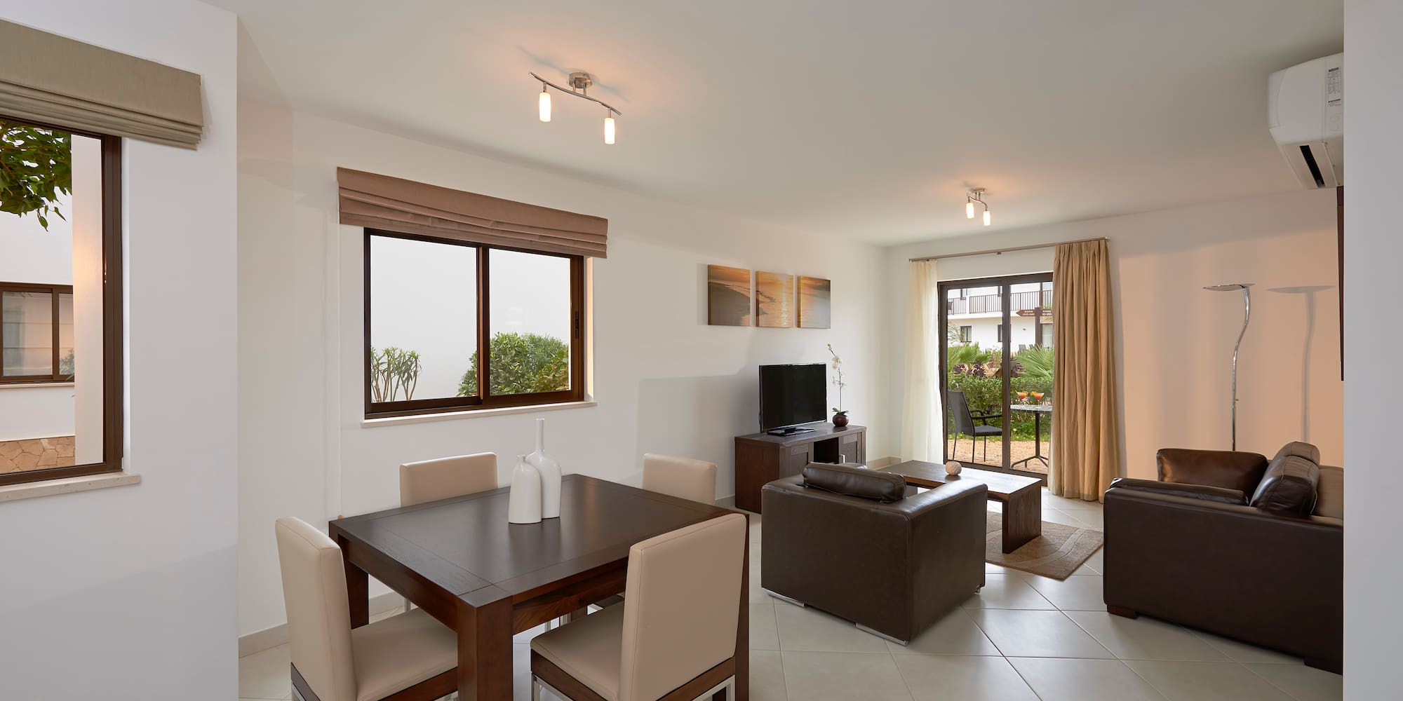 a living room with a table and chairs