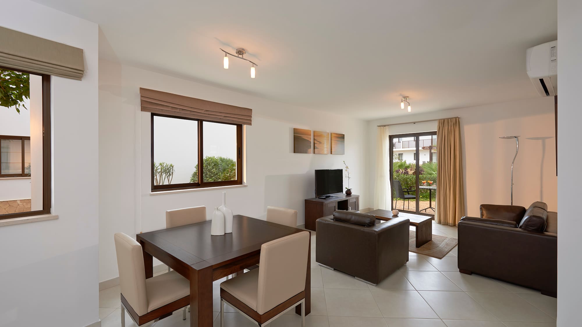 a living room with a table and chairs