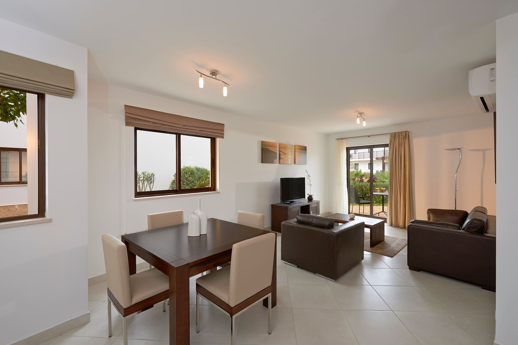 a living room with a table and chairs