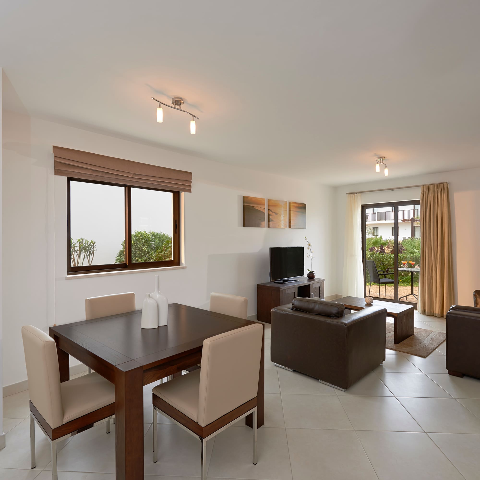 a living room with a table and chairs