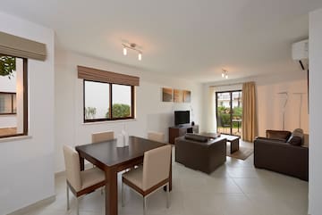 a living room with a table and chairs