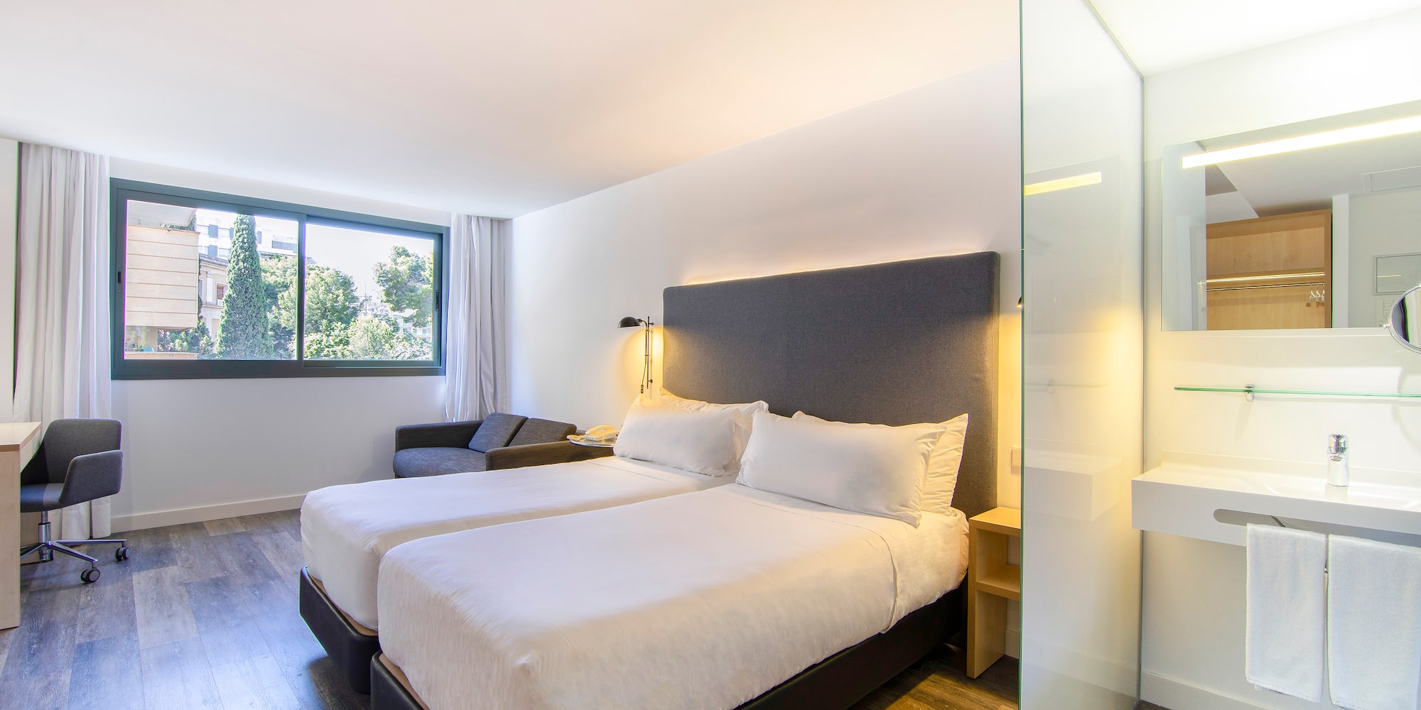 a room with two beds and a window