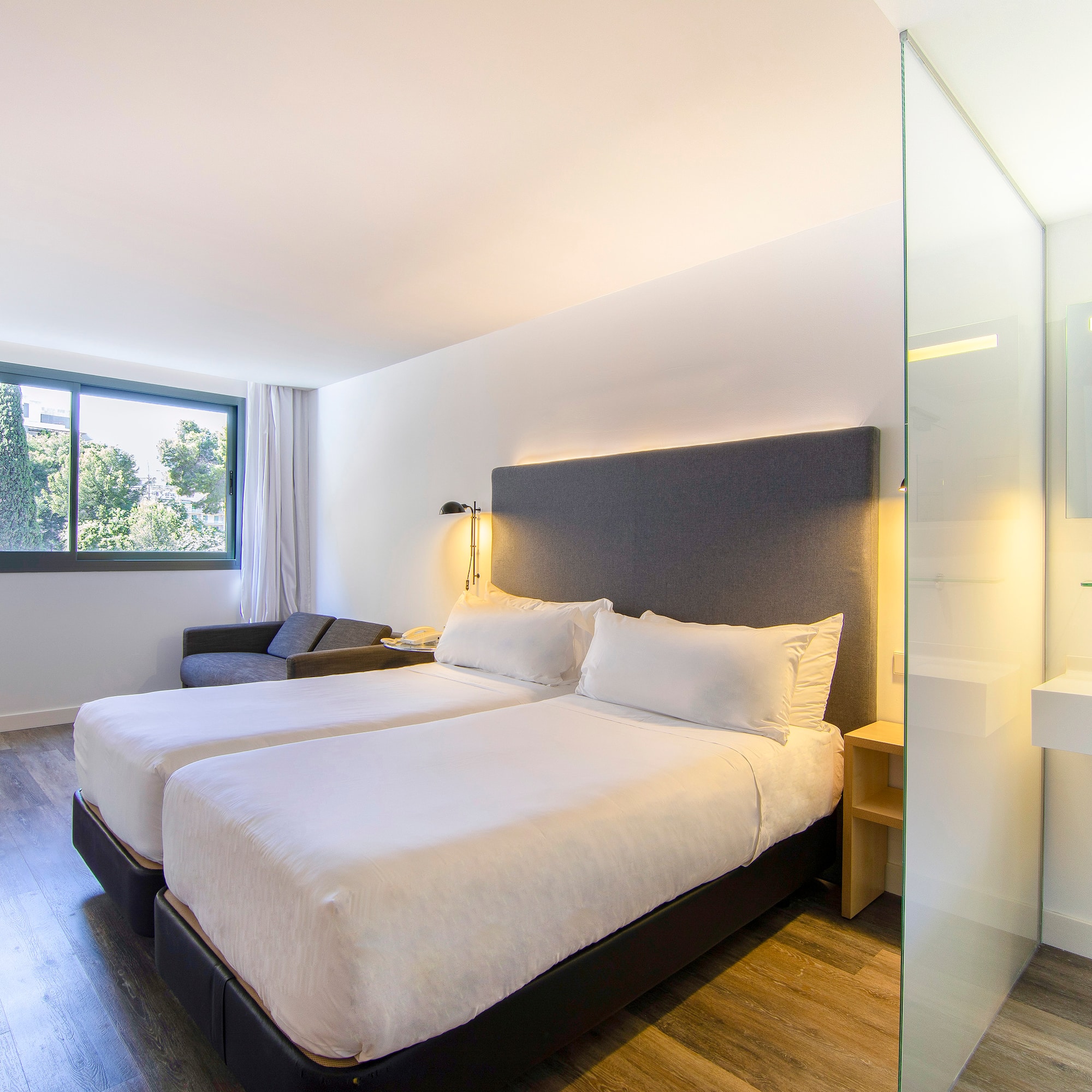 a room with two beds and a window