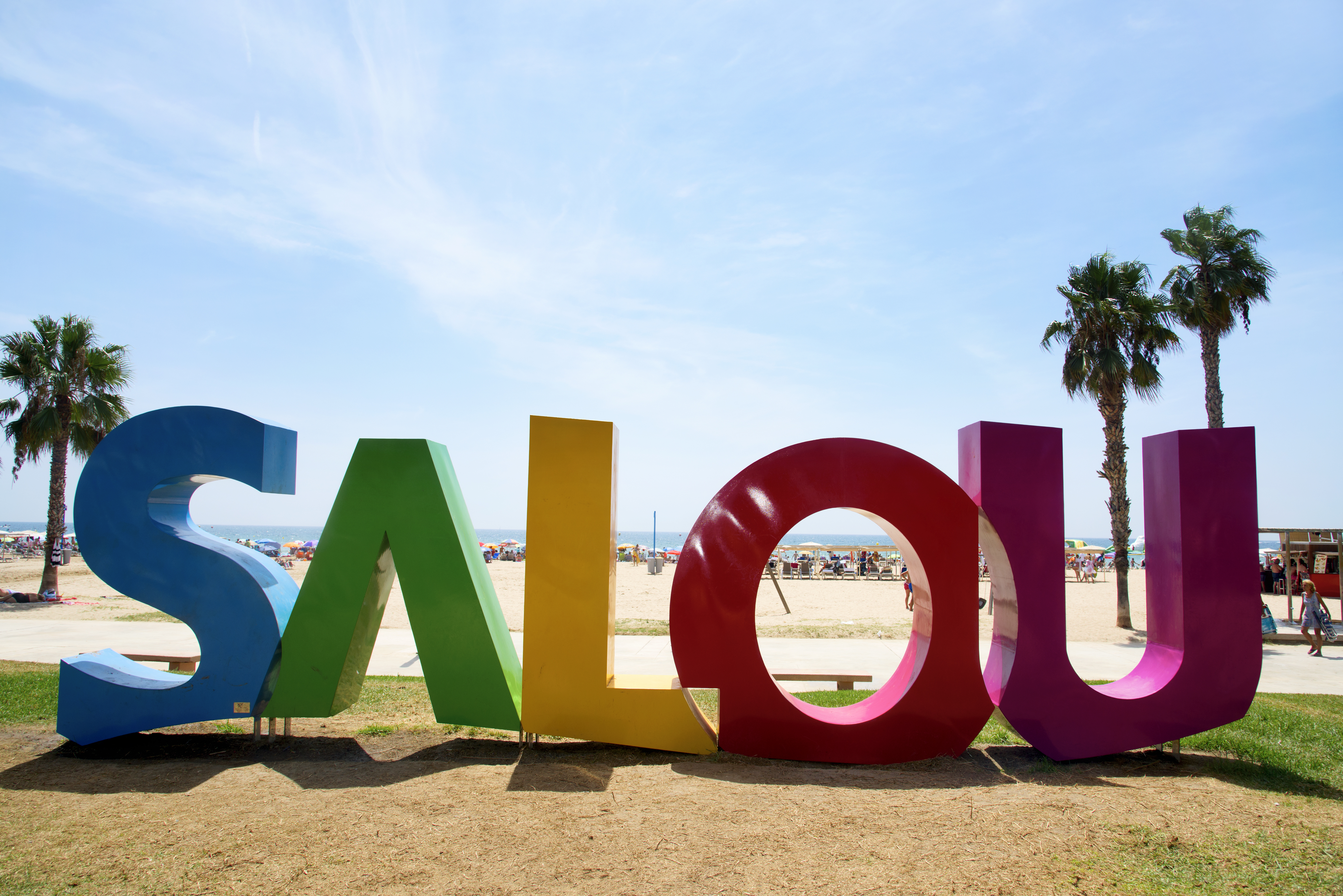 a colorful sign on a beach