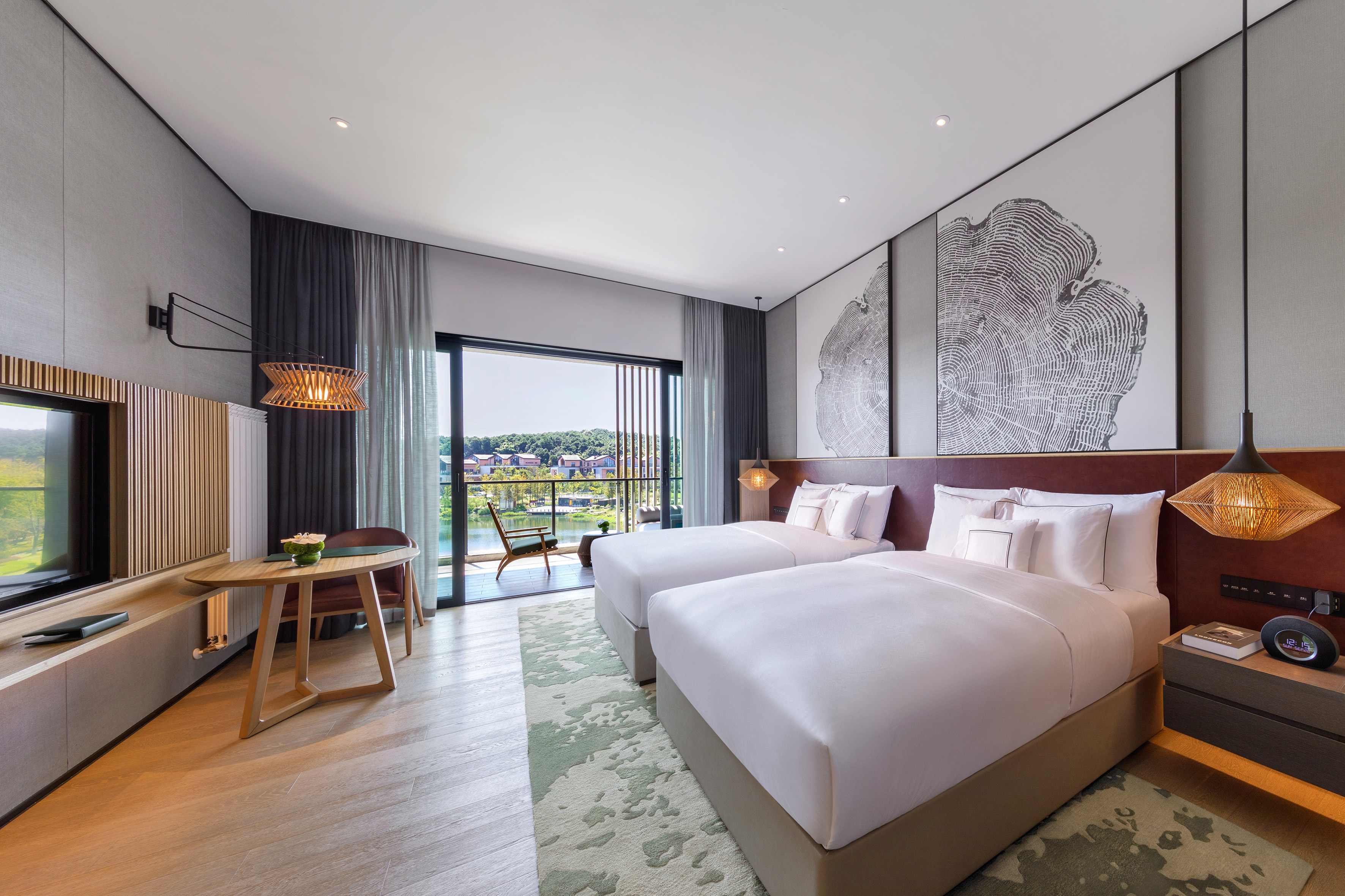 Modern hotel twin room with lake view balcony and contemporary design.