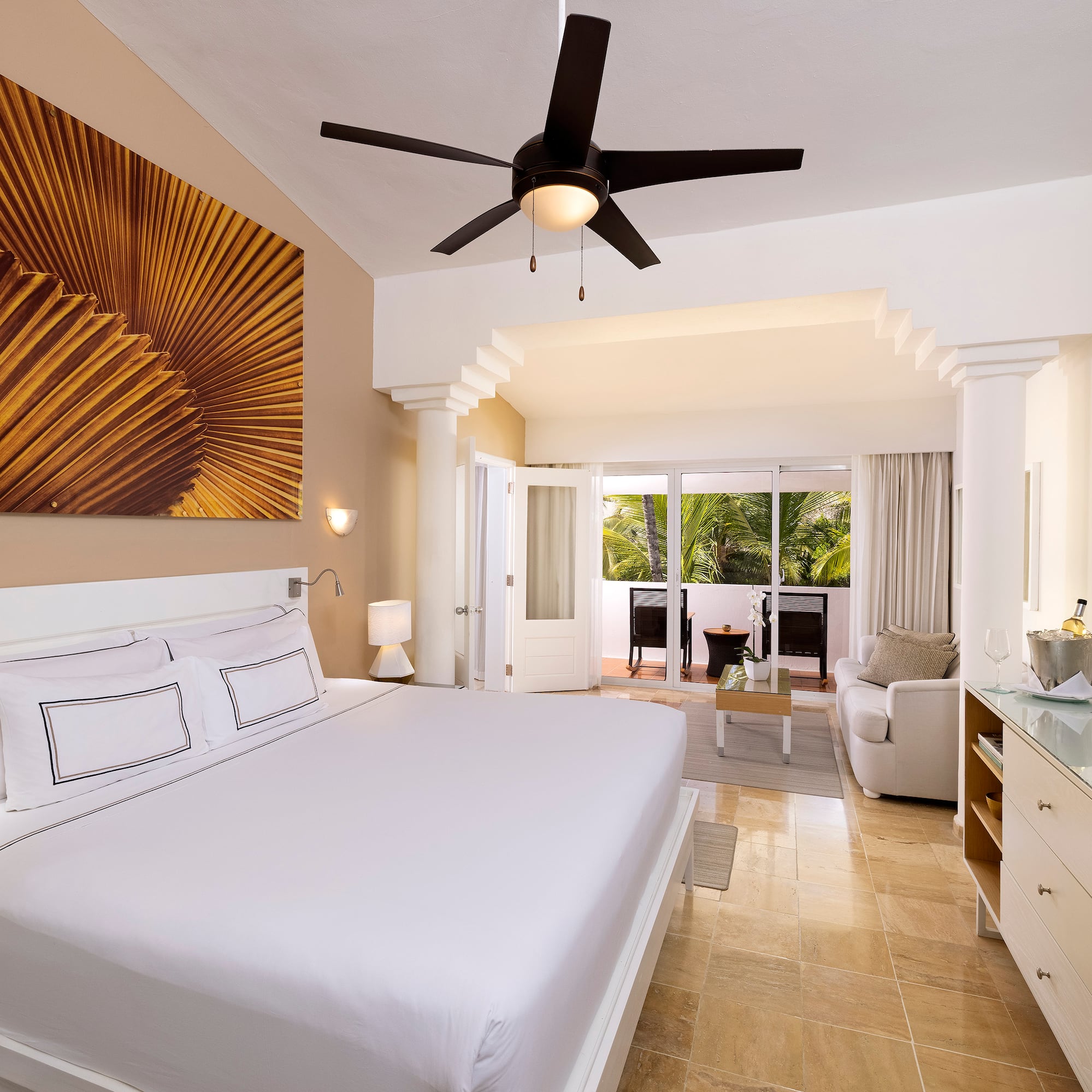 a bedroom with a ceiling fan and a bed