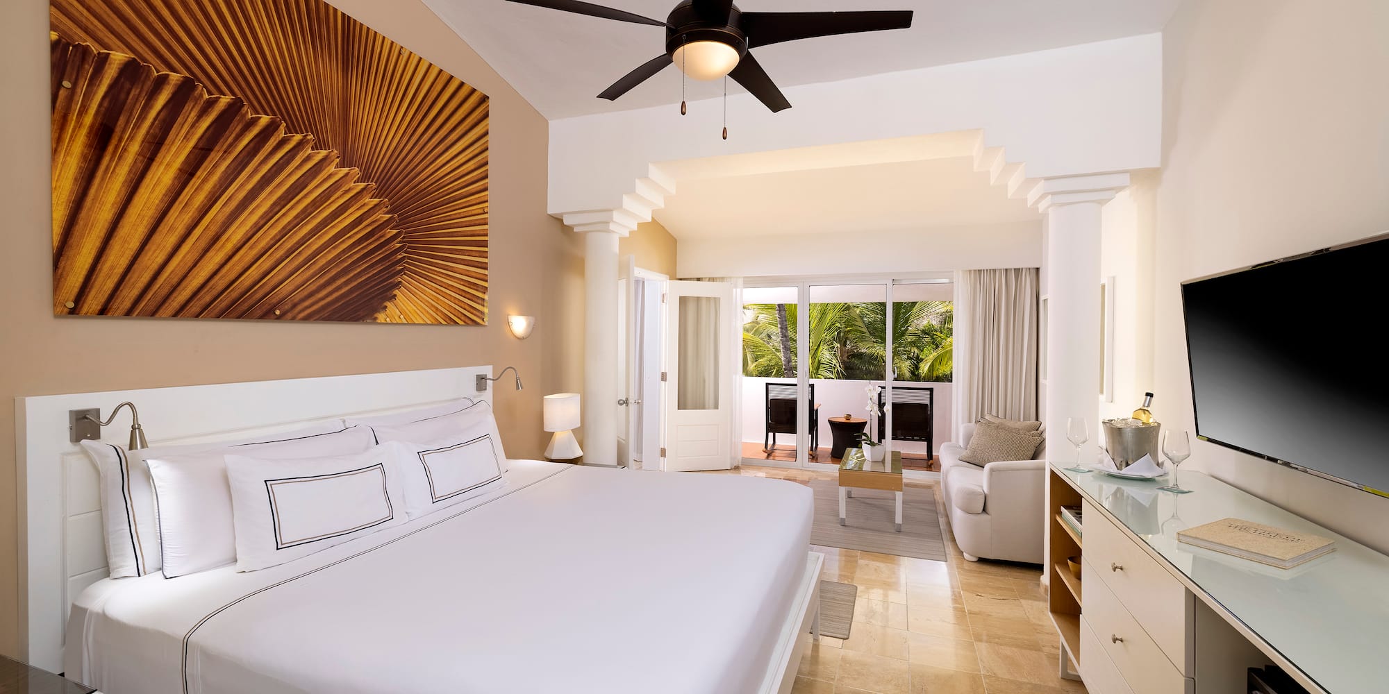 a bedroom with a ceiling fan and a bed