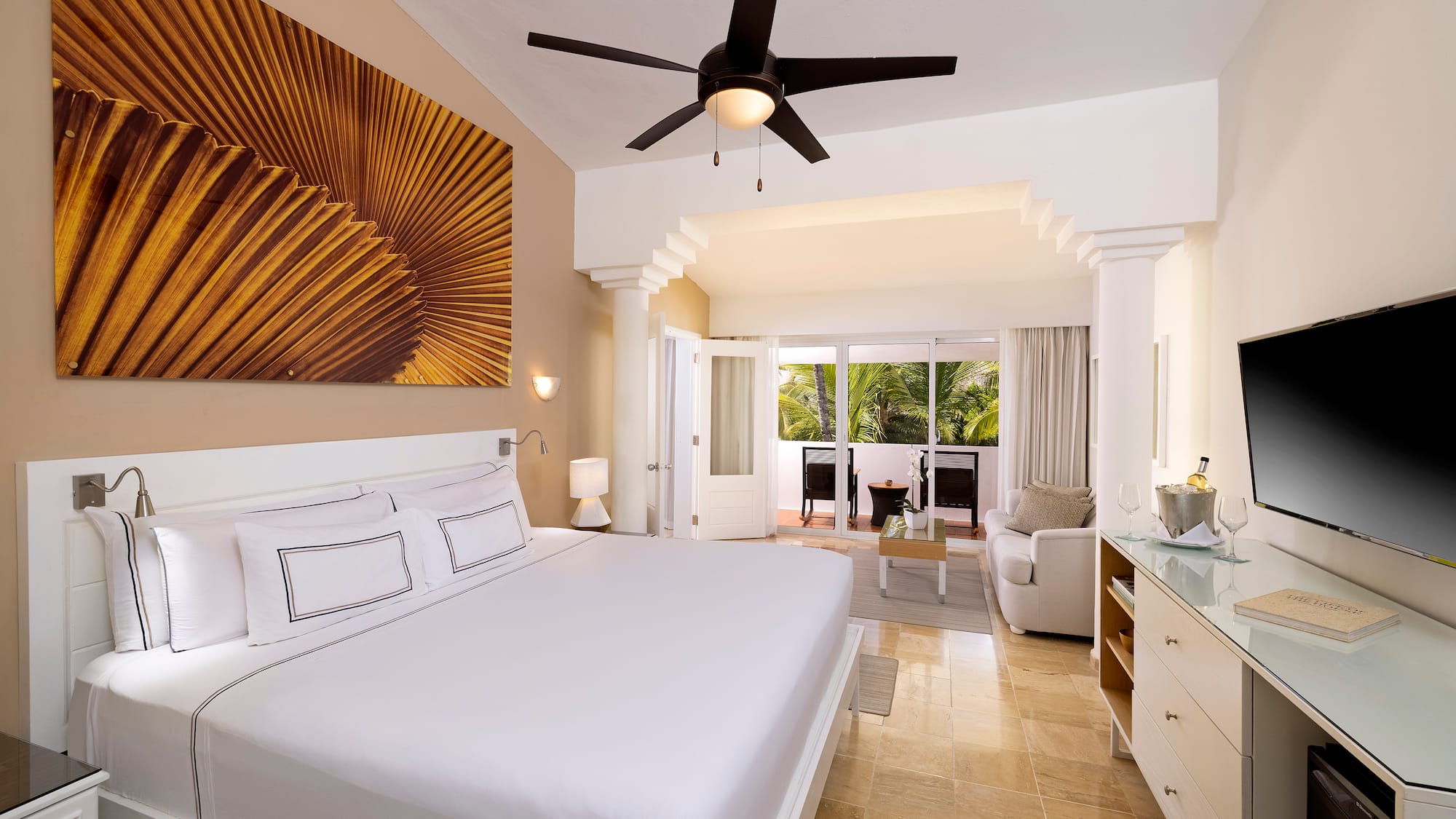 a bedroom with a ceiling fan and a bed