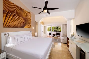 a bedroom with a ceiling fan and a bed