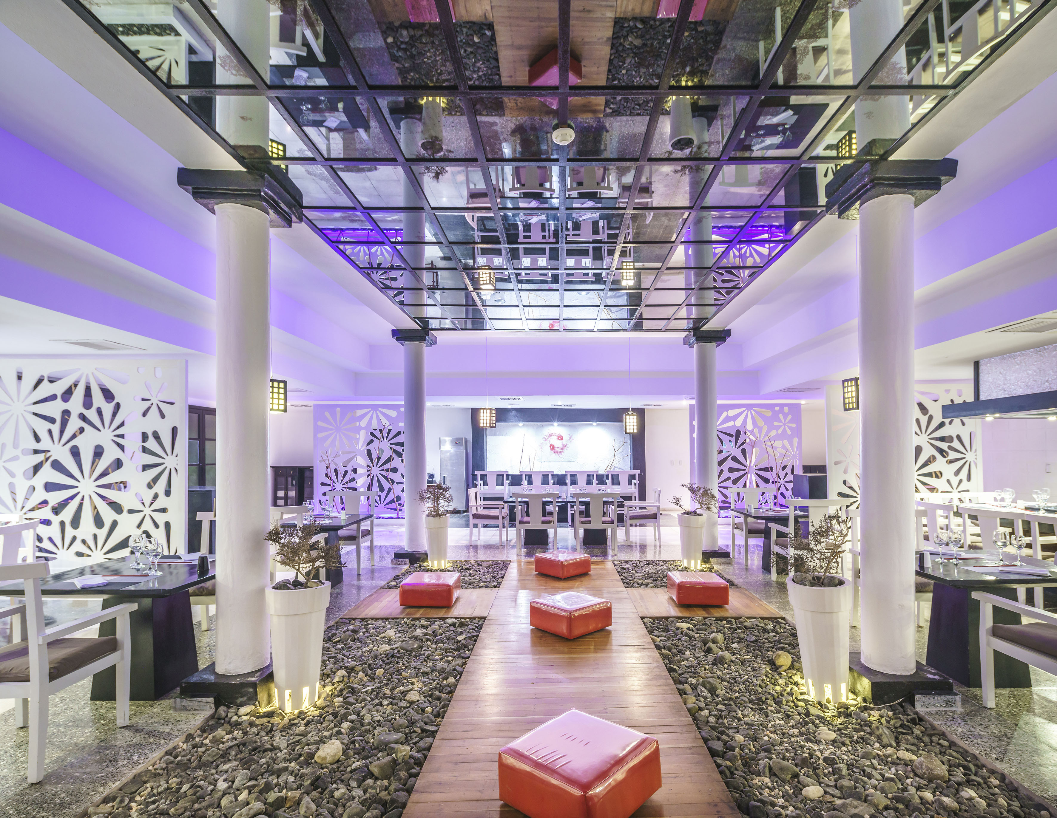 a room with a glass ceiling and a large white wall