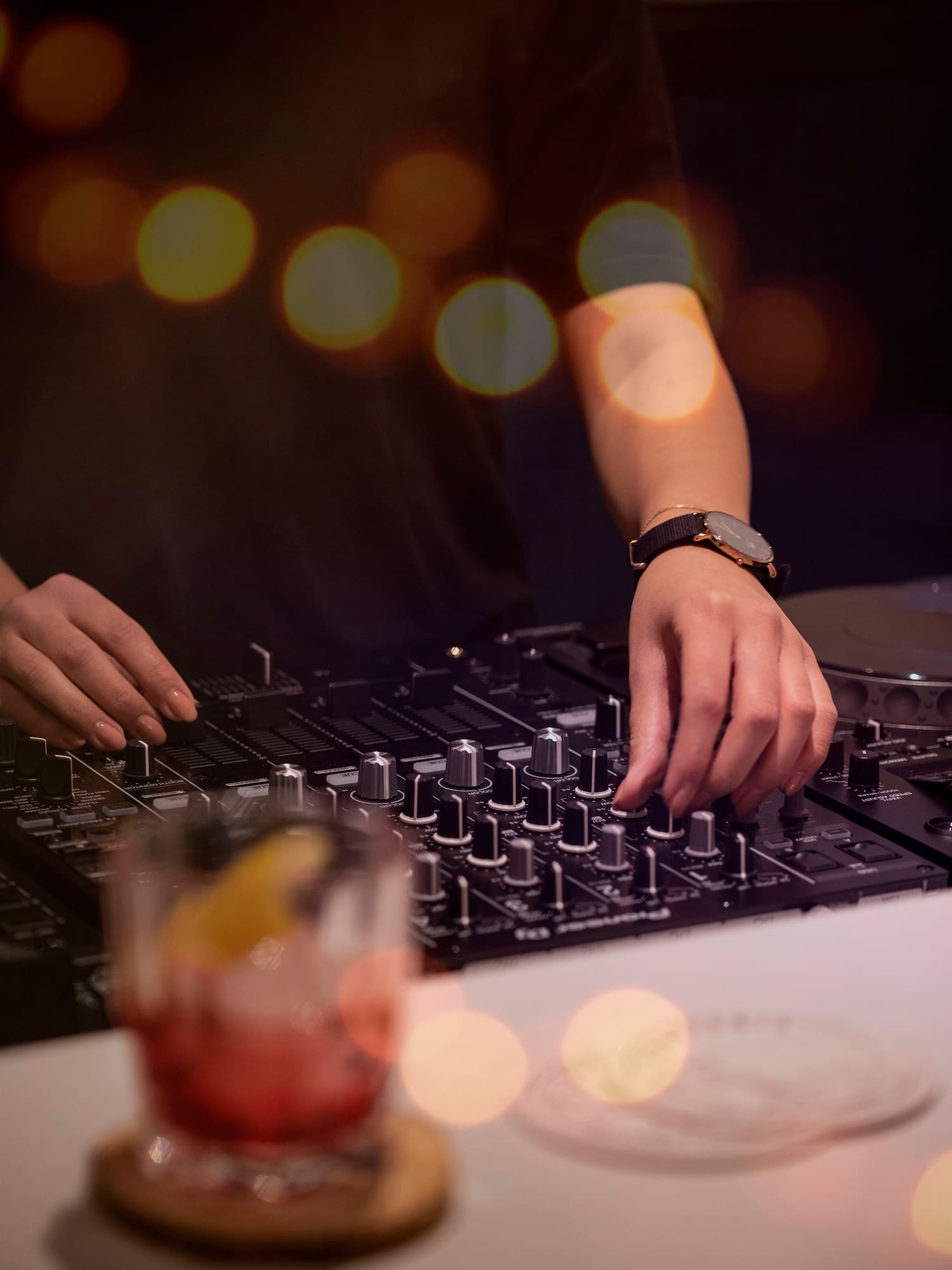 a person playing music on a mixer