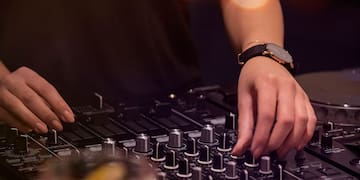 a person playing music on a mixer
