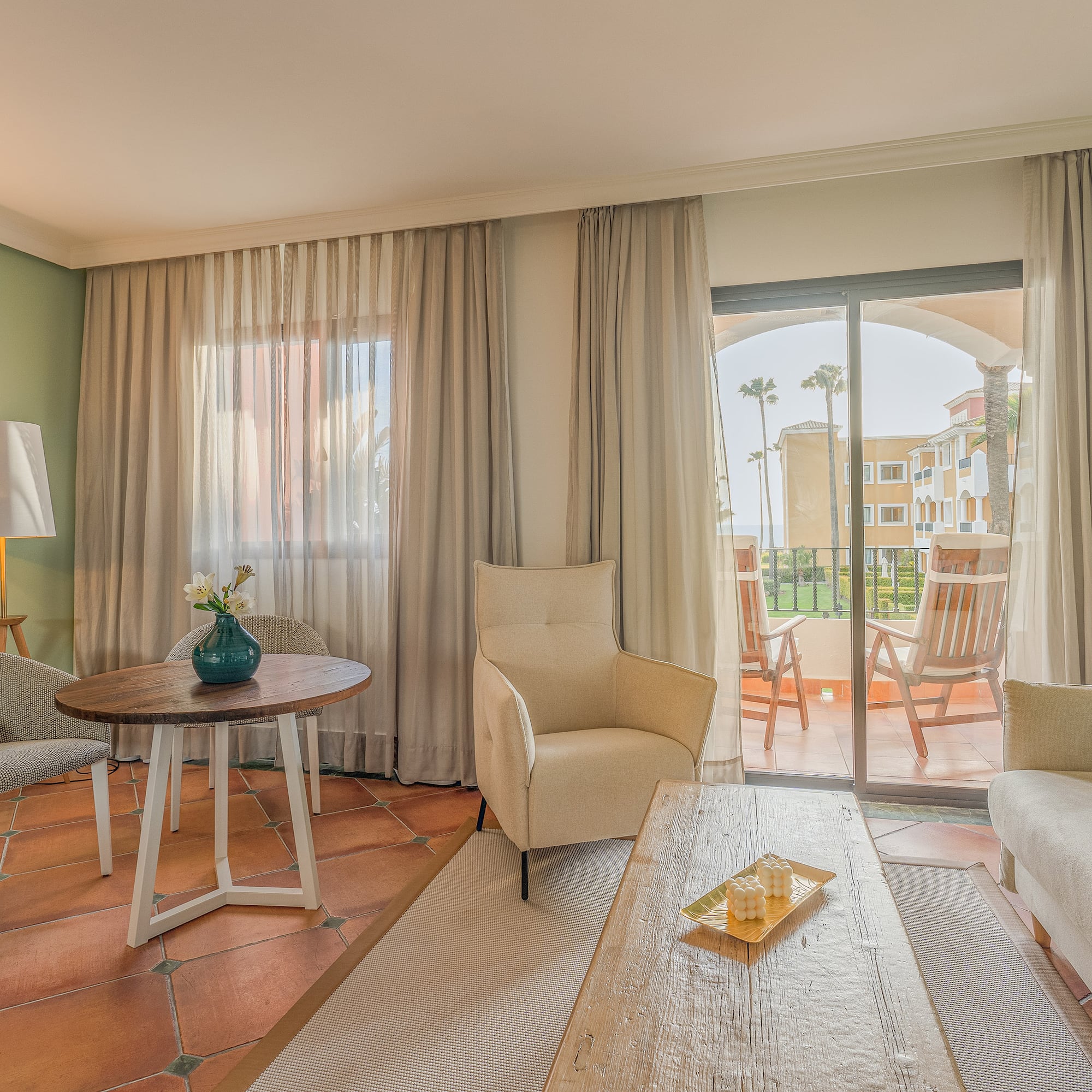 a living room with a glass door and a table and chairs