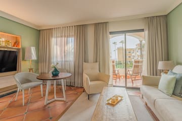 a living room with a glass door and a table and chairs