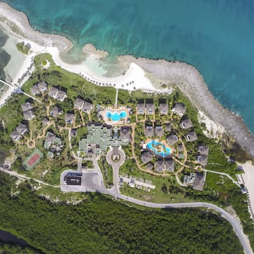 a aerial view of a resort with a pool and a body of water