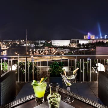 a table with drinks on it and a city in the background