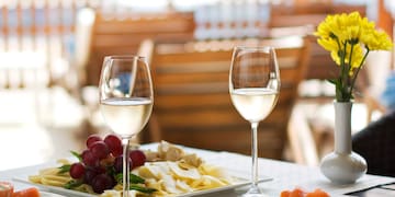 a table with plates of food and wine glasses