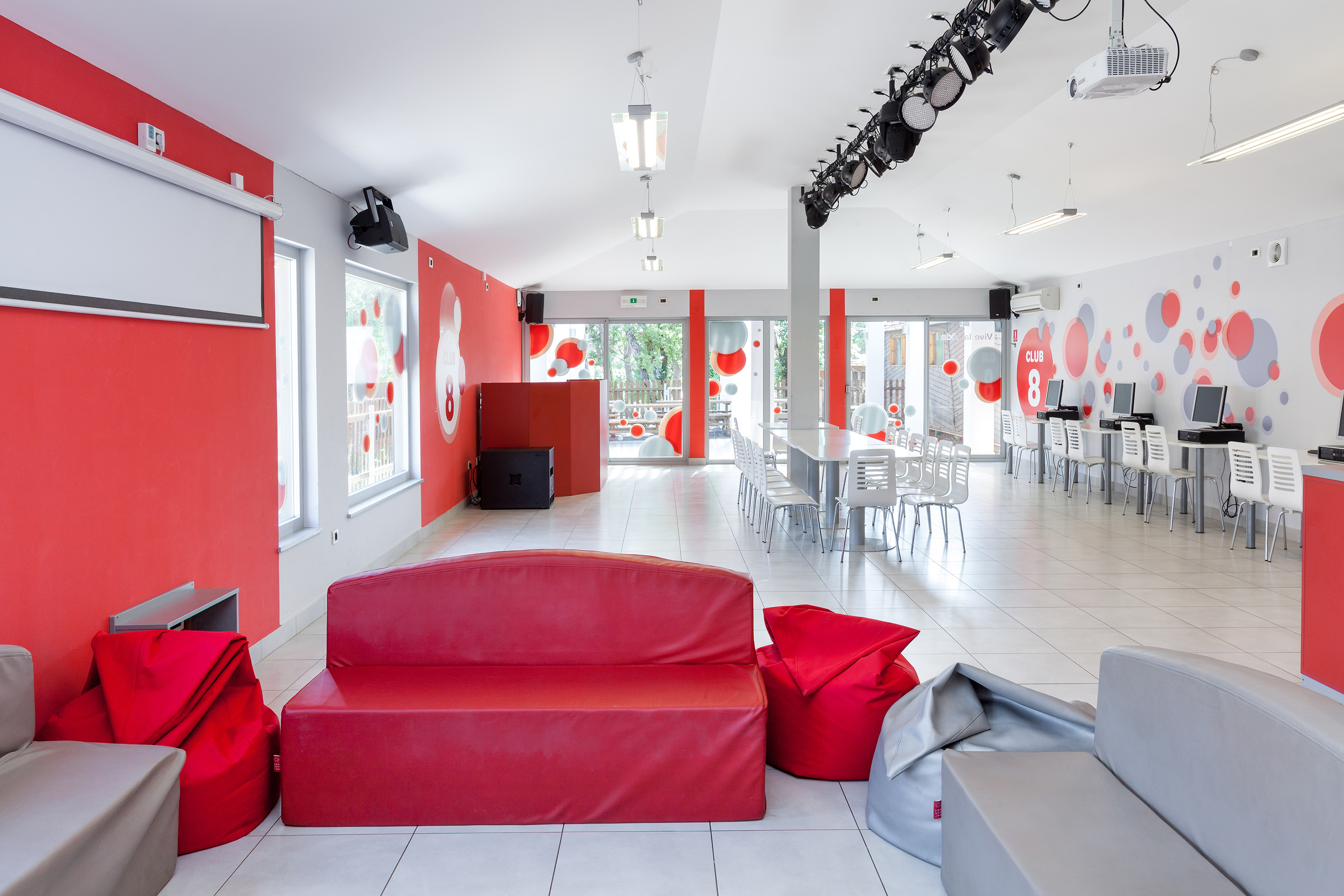a room with red couches and chairs