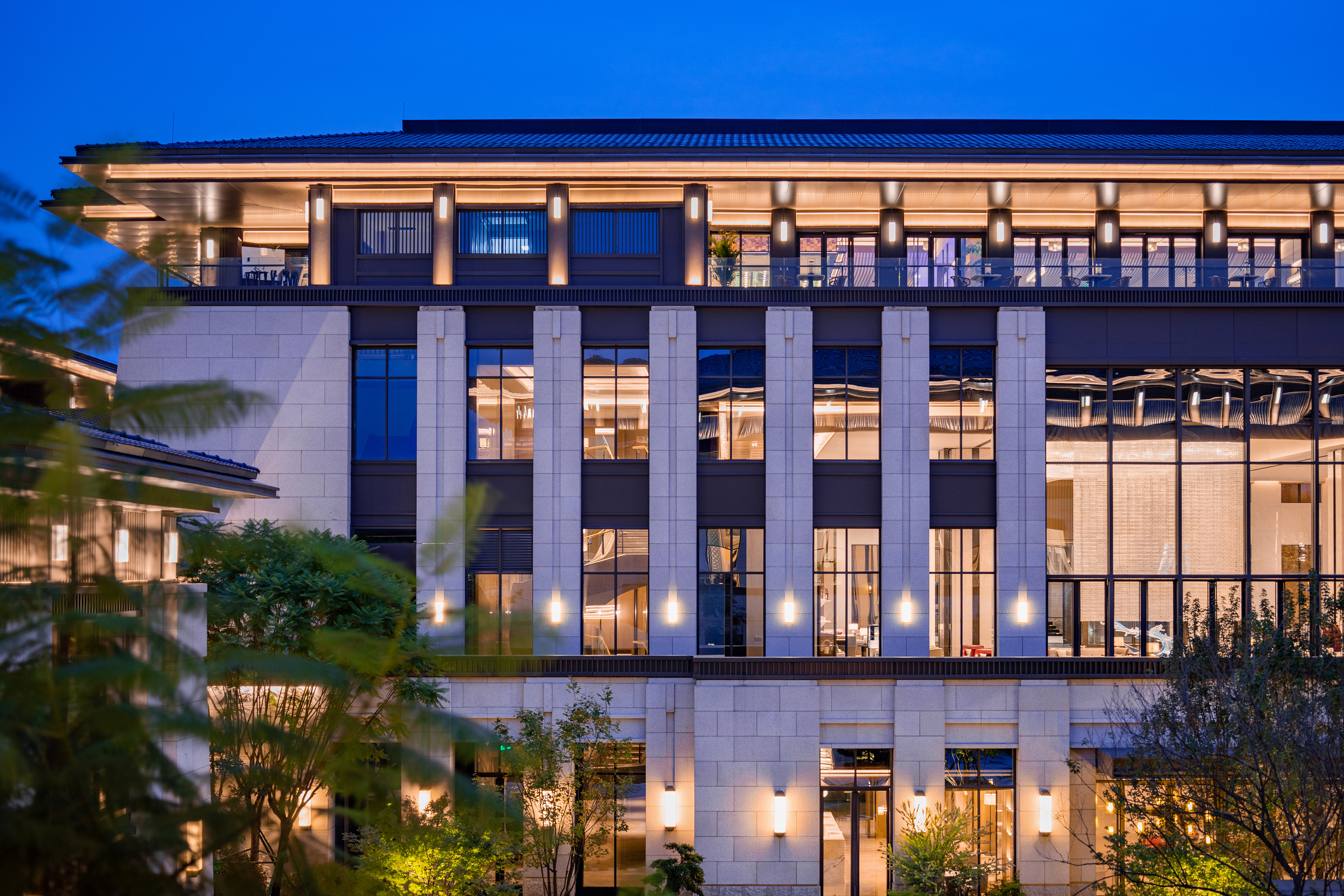 Luxury hotel building facade illuminated at night, modern architecture.