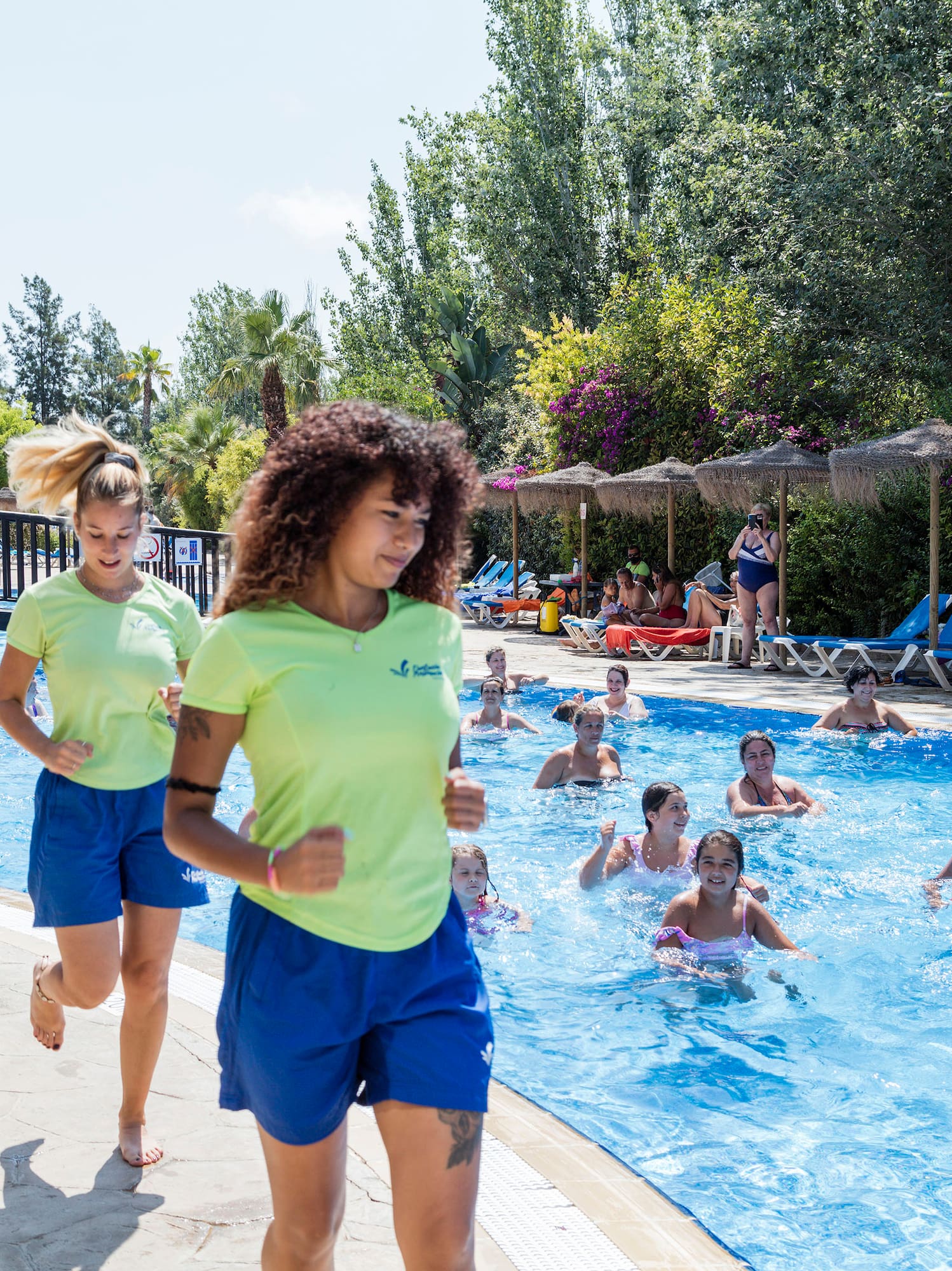 a group of people running in a pool