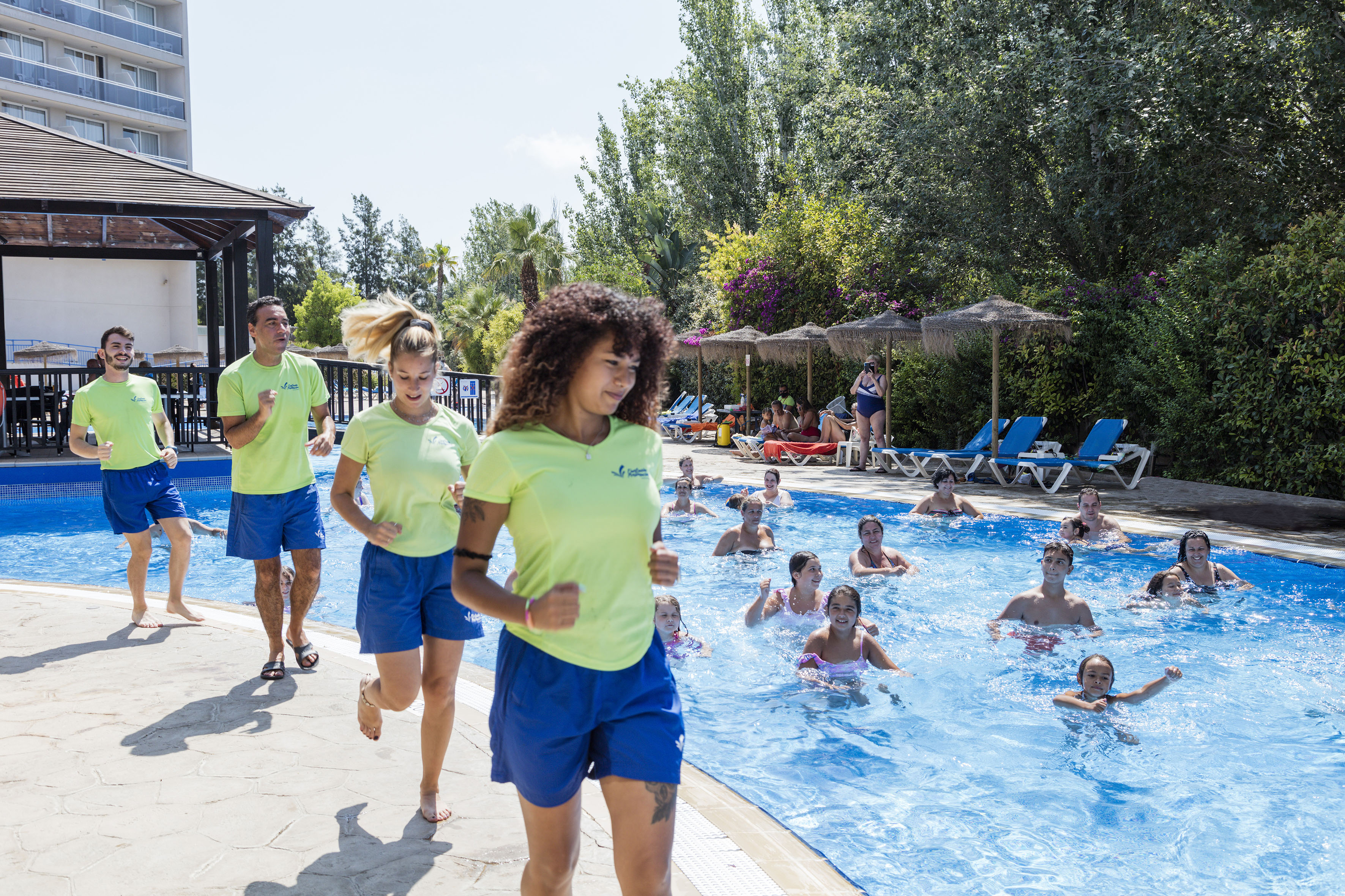 a group of people running in a pool