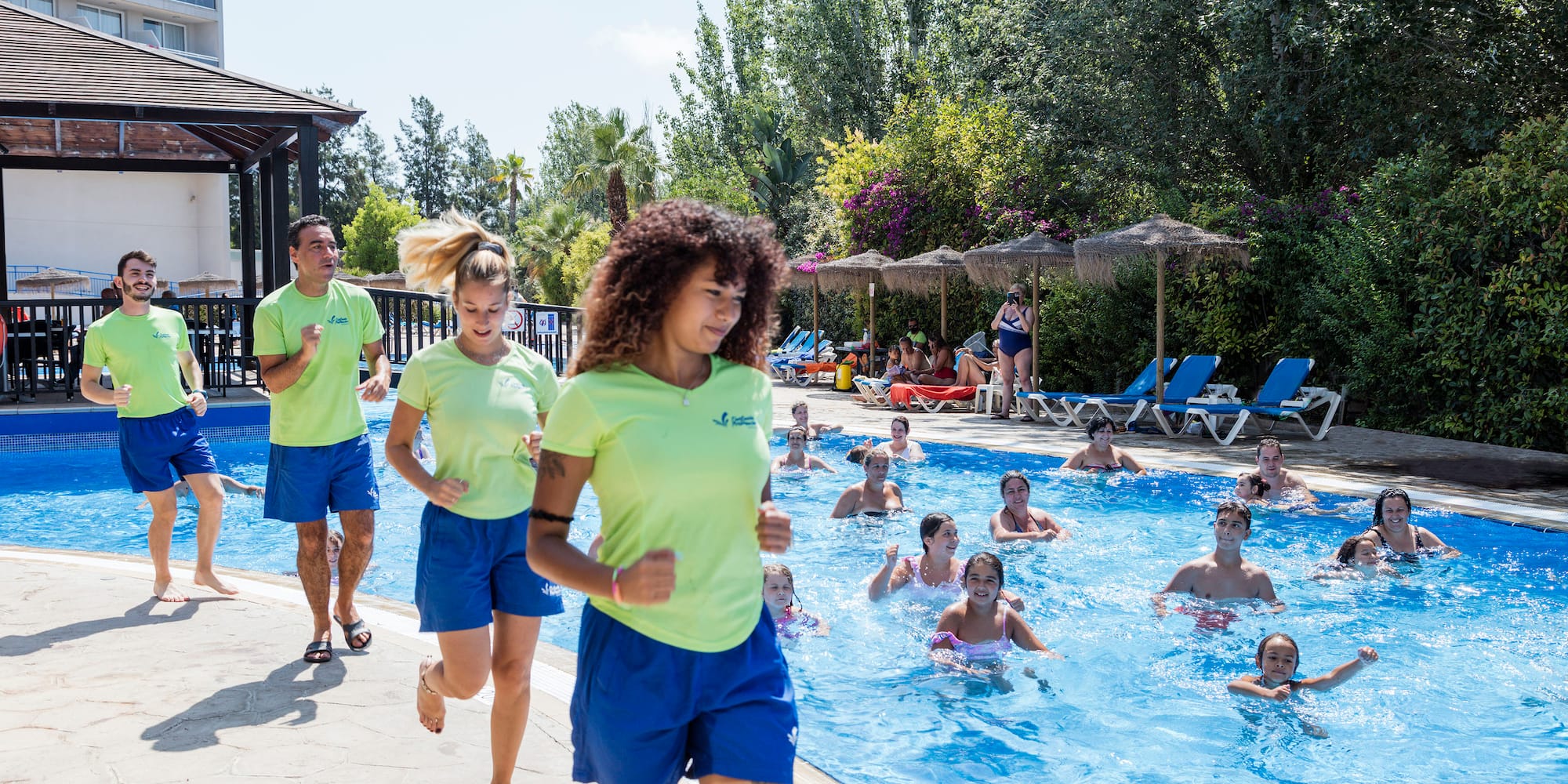 a group of people running in a pool