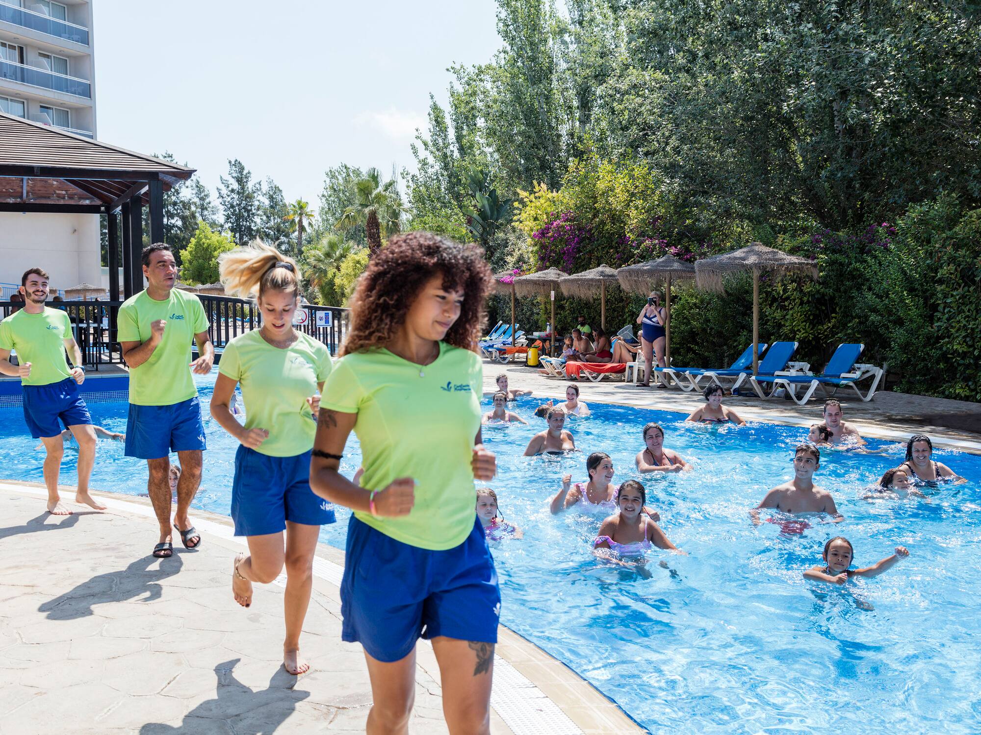 a group of people running in a pool