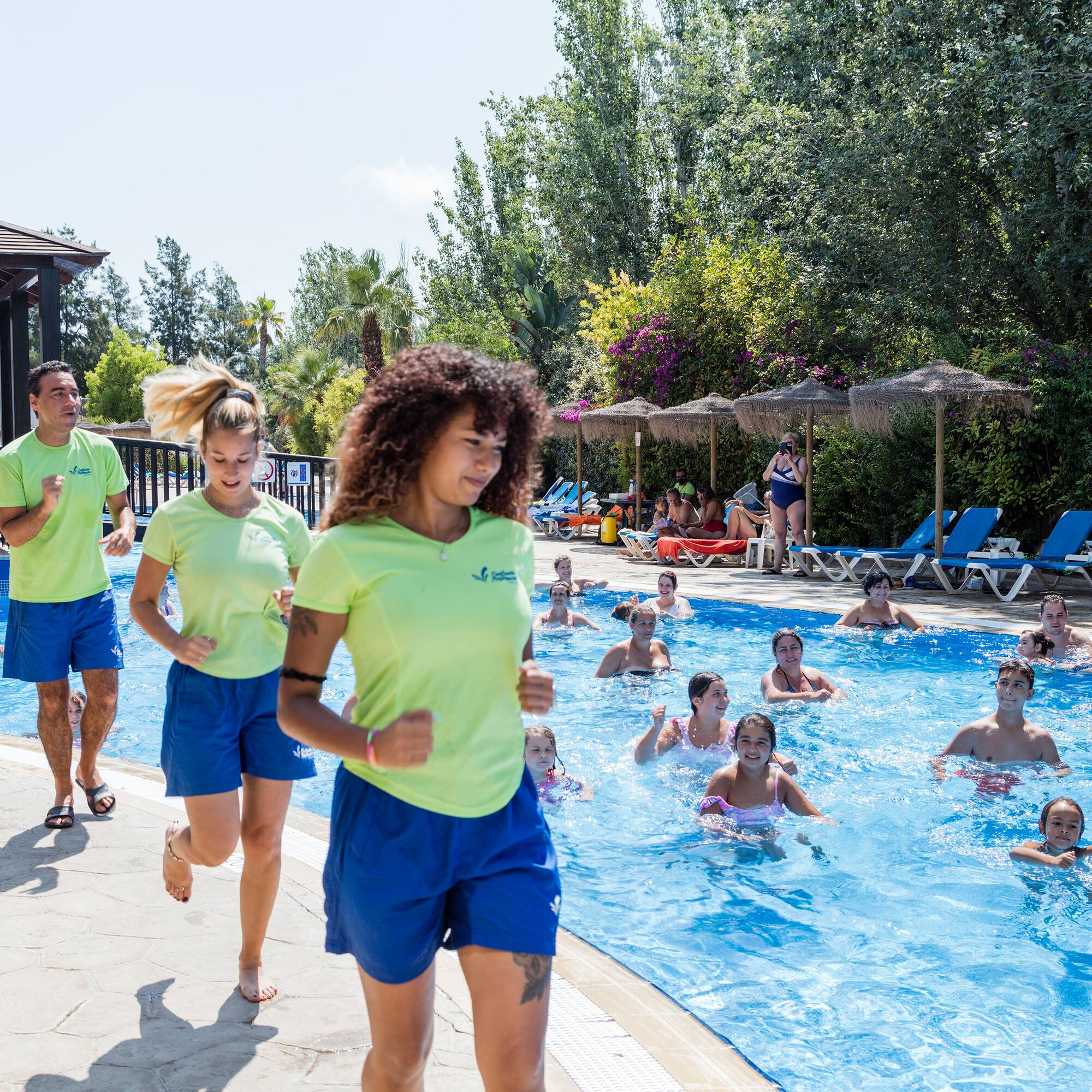 a group of people running in a pool