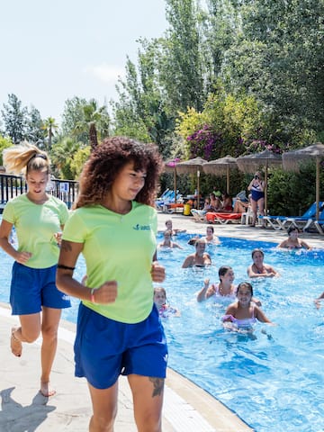 a group of people running in a pool